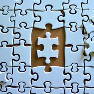 A piece of jigsaw puzzle missing a piece.