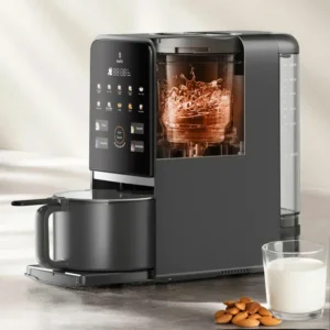 A black modern nut milk maker with digital controls, a transparent blending chamber, and a glass of milk beside a small pile of almonds on the counter.